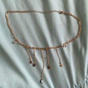 gold necklace with dangling stars and moon